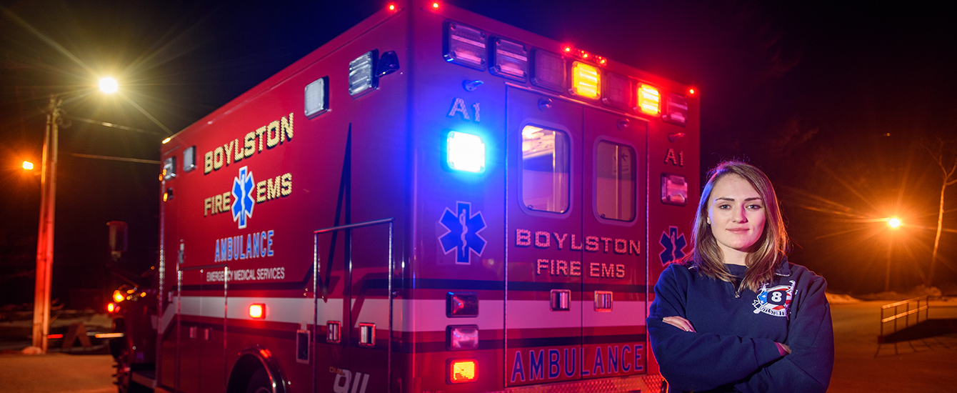 EMT drver in front of ambulance