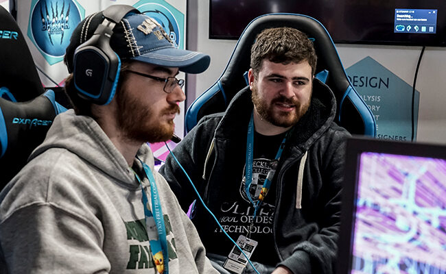Two gamers watching screen at PAX East 2020