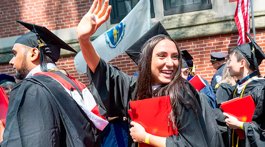 girl waving in graduation ceremony