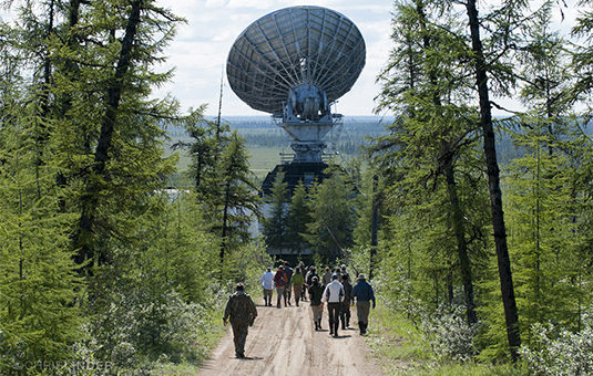 students walking to large satelite