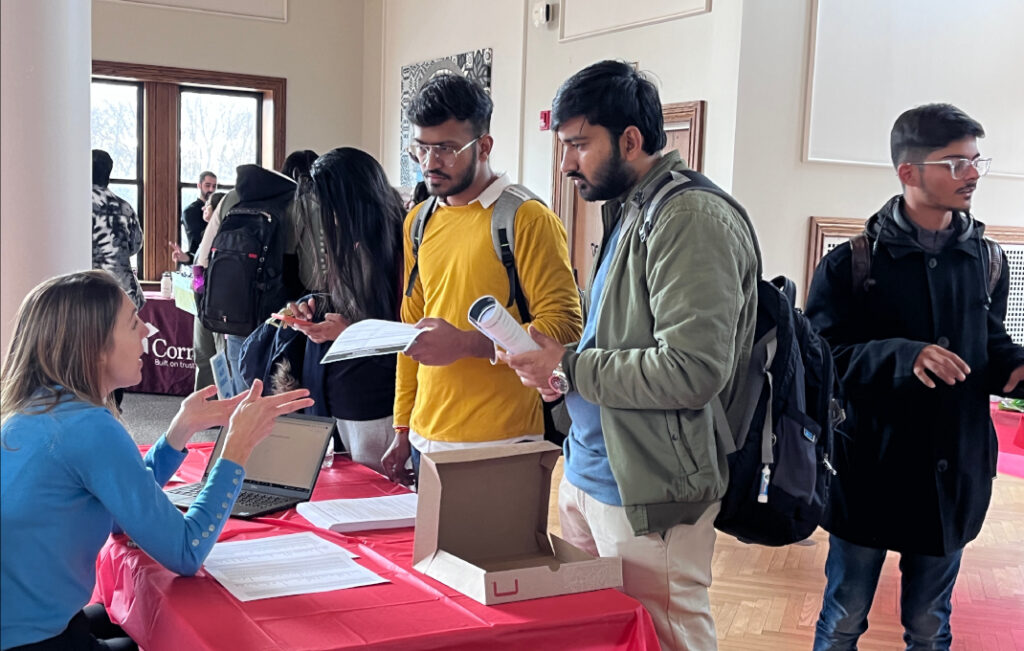 Students talking to staff member at fair