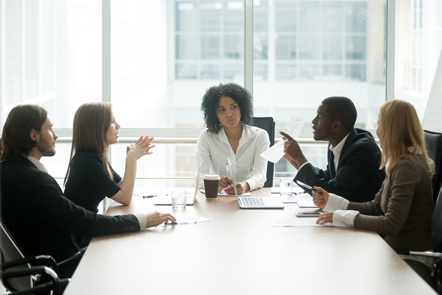 diverse team sitting around table in discussions