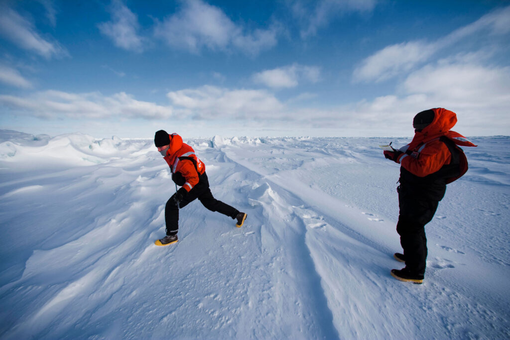 Professor Karen Frey conducts research in a snowy Arctic landscape