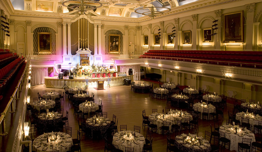 picture of white tables in great hall for performance