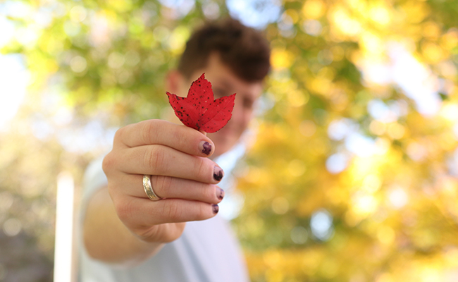 student holding up leaf
