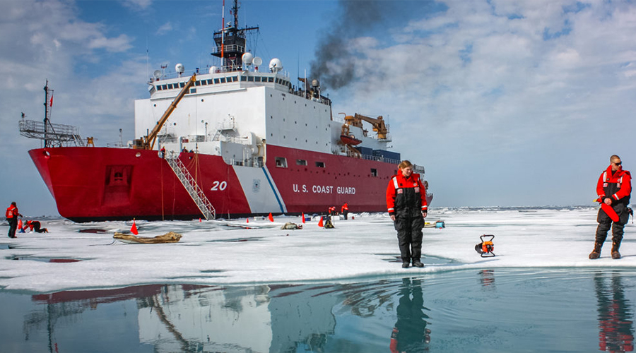 Karen Frey on iceberg with ship in background