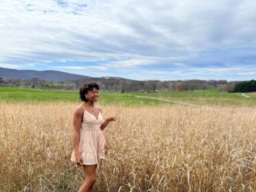 Olivia Barksdale '19 stands in a field of tall grass at the Storm King Art Center, NY. Spring 2019