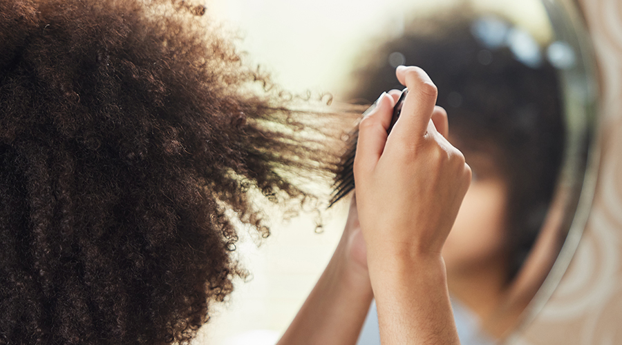 Black woman combing hair
