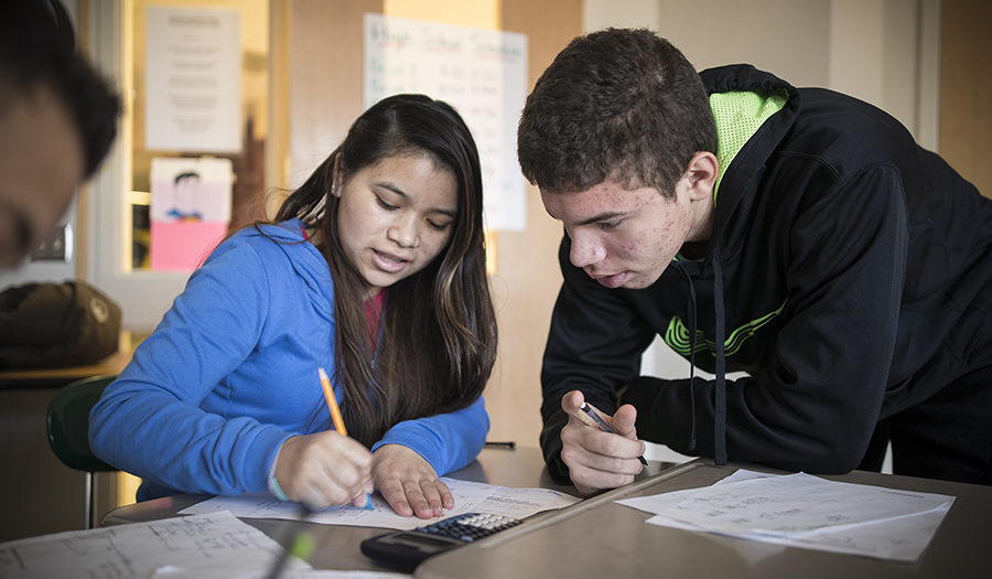 two students helping each other with homework