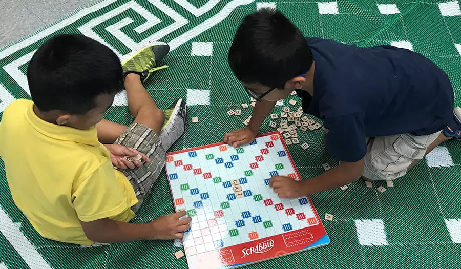 young boys playing board game