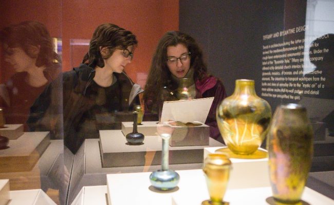 Students looking at vase exhibit