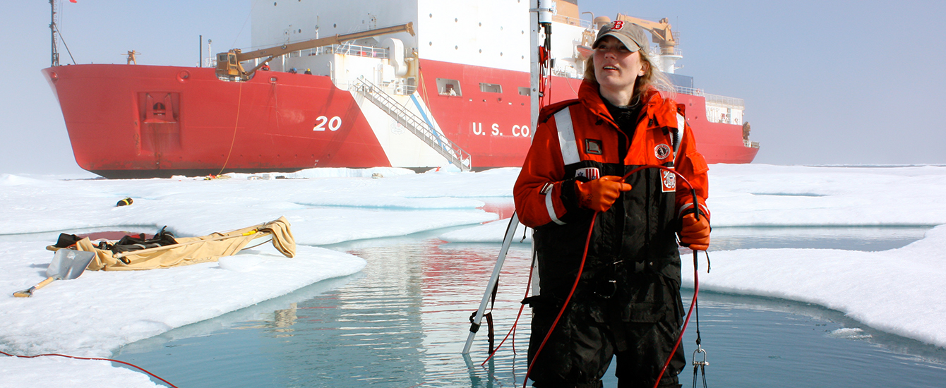 Faculty member standing in water in Arctic