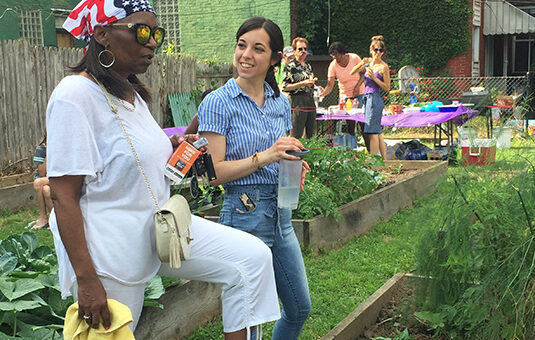 Uptown partners with people working in garden