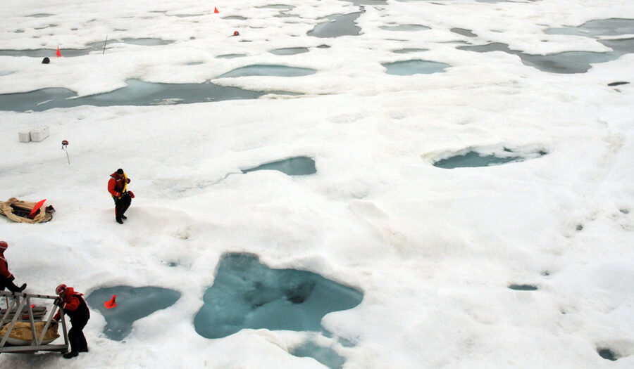 Arctic ice with scientists near ship