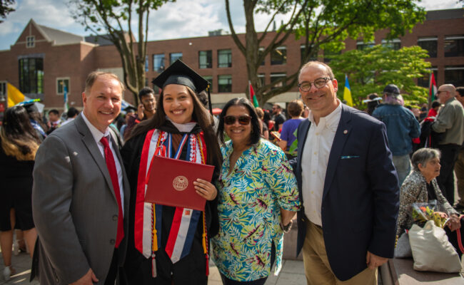 Commencement graduate with parents and David Fithian