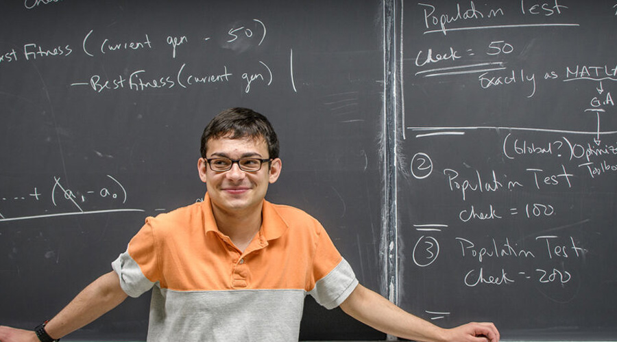 mathematics student in front of chalk board