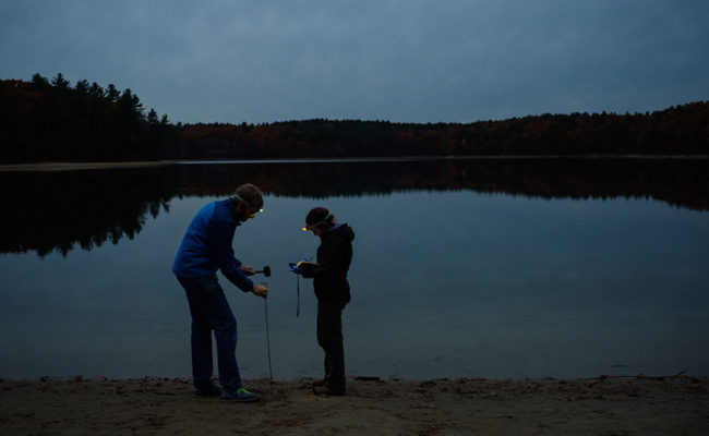 Professor and student at Walden Pond conducting tests