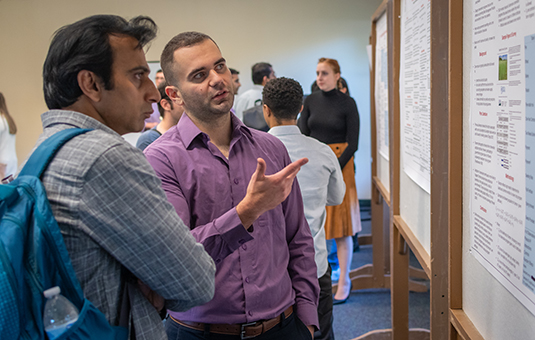 Students discussing research poster