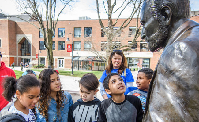 young students admiring Sigmund Freud statue