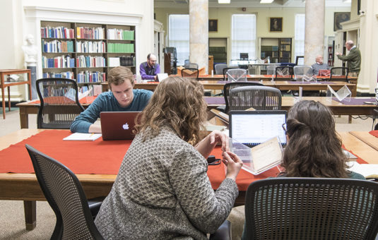 Students and faculty studying in archives