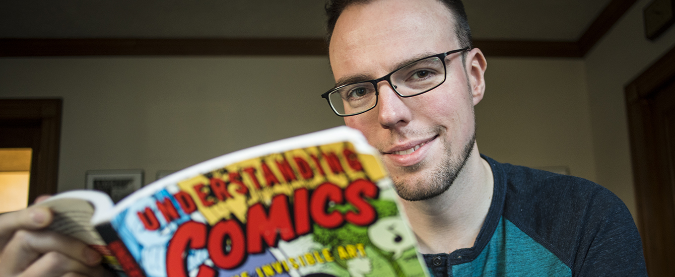 Student holding a comic book
