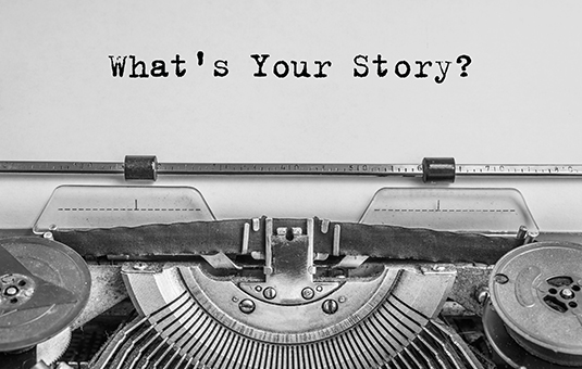 old typewriter with words on page typed as "what's your story?"