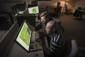 two men looking at heat maps