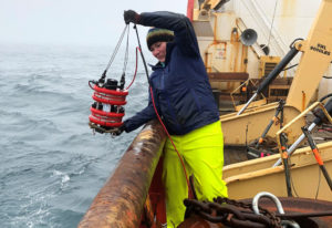 Karen Frey pulling up water sample from ocean