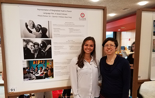 Student and professor standing in front of research poster
