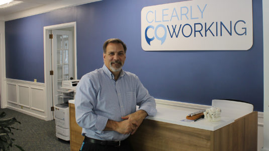 Robert DelMastro at front desk of Clearly Coworking