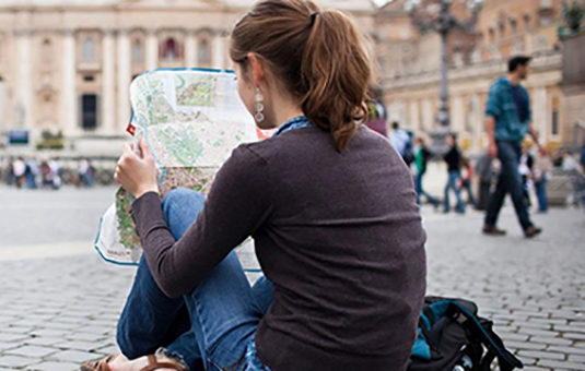 study abroad student reading map