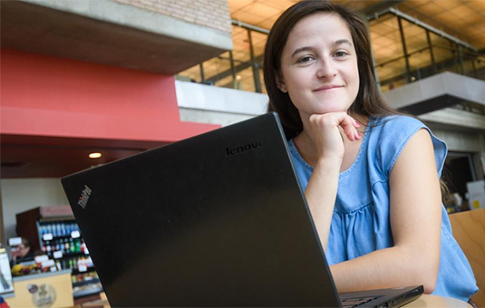 student sitting at laptop