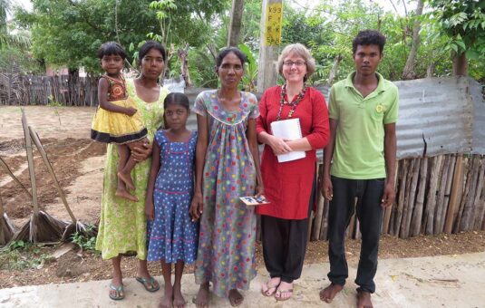 Professor Cindy Caron with a group of people during a research project.