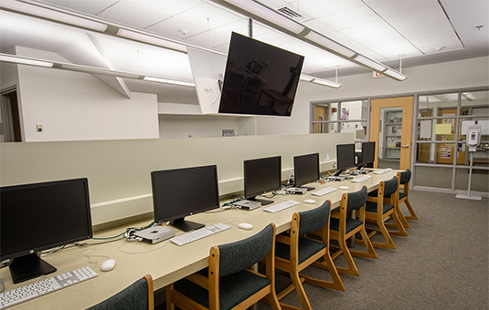 Fuller media center with desks/tables/media screen