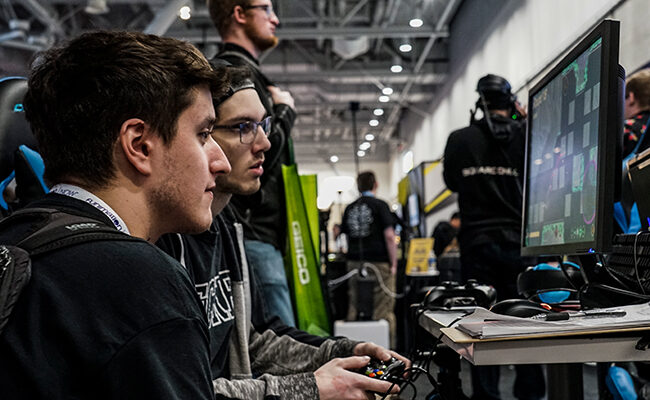 Two men playing video game at PAX East 2020