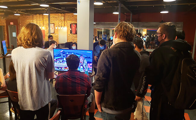 Gamers watching Smash Bros. game