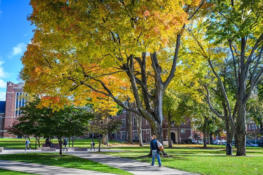 student walking on campus in fall