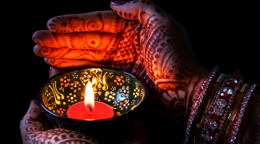 Diwali thanksgiving - hands holding candle