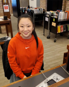 Student employee sitting at library desk