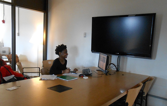 student study room with large monitor hooked up to laptop with chairs and a table