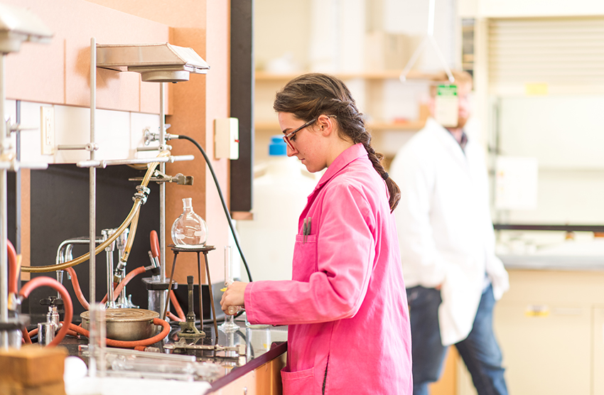 Arthur M. Sackler Sciences Center - young woman looking over lab equipment