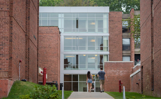 Hughes Residence Hall - students walking into building