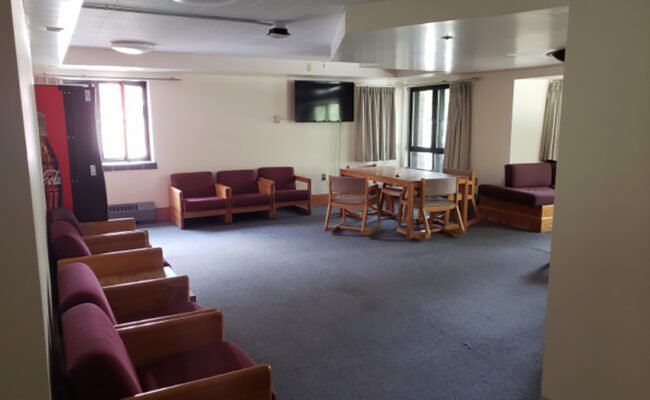 Maywood Residence Hall - open living space with couches, tvs