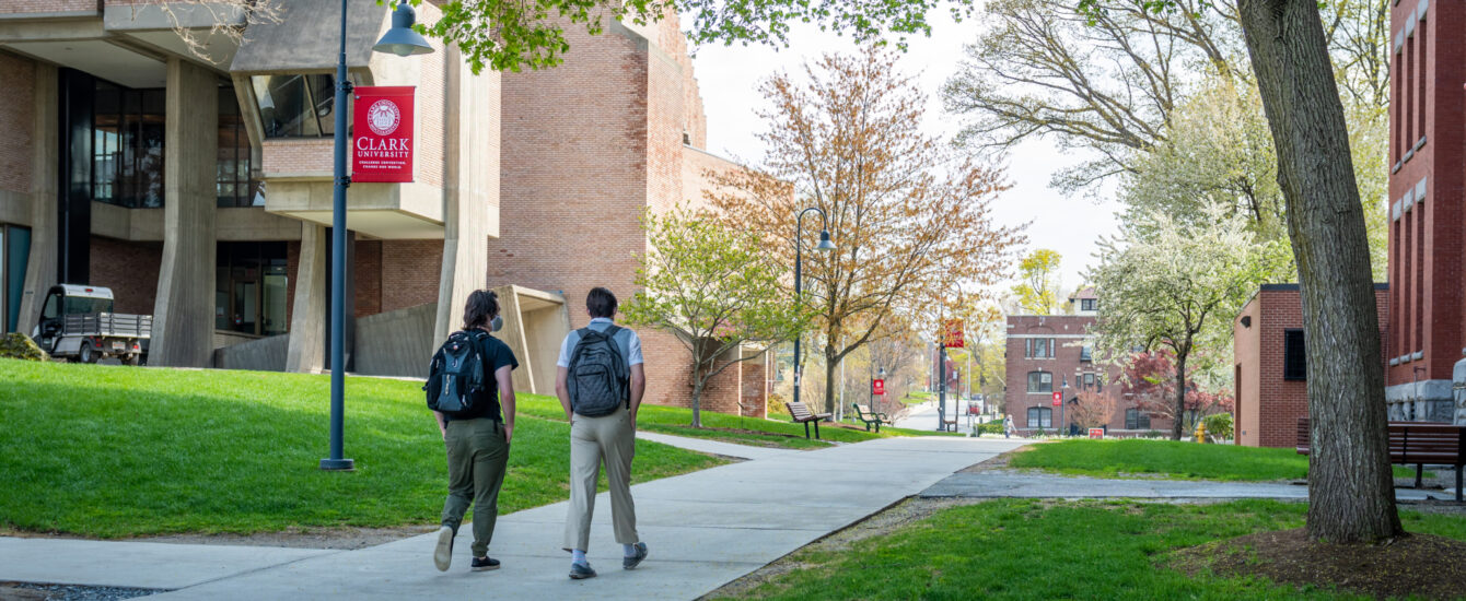 Two students walking through Clark campus