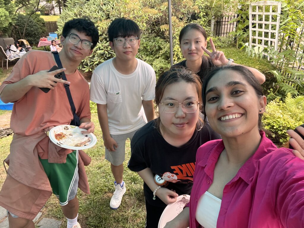 A selfie of HFUT students at barbecue with empty plates and smiling faces