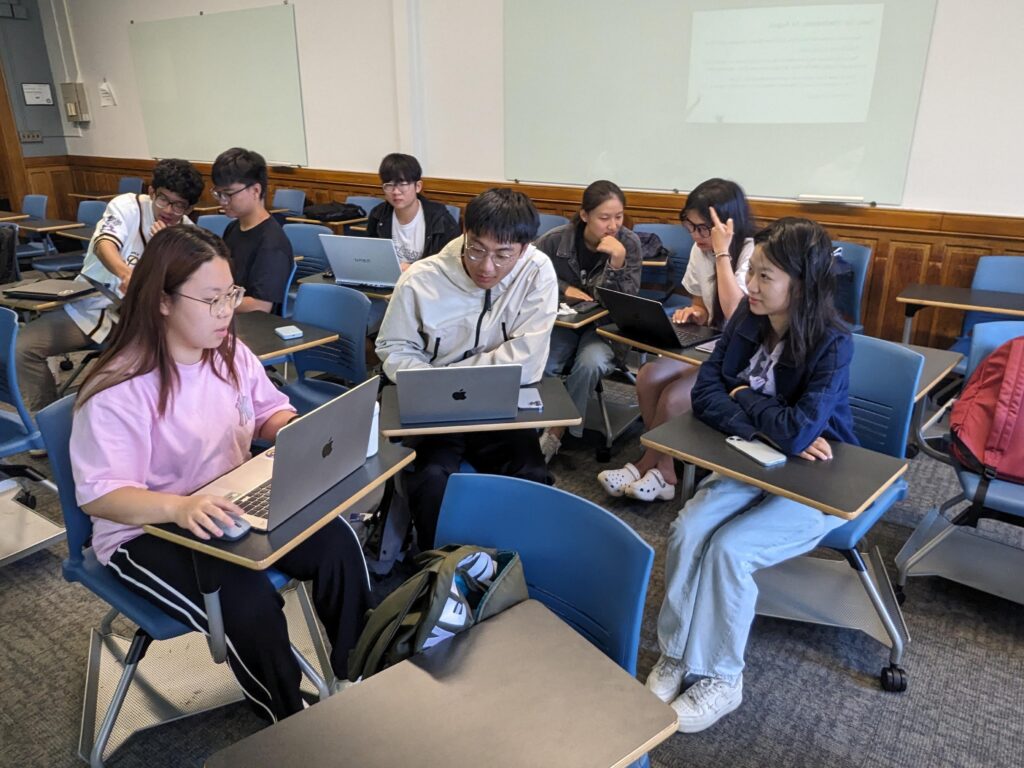 A group of students working together in small groups in a classroom