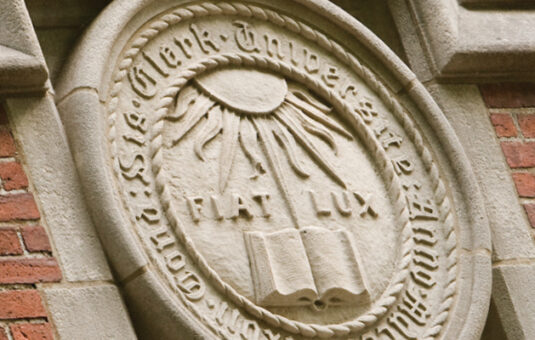 Carved stone seal with the words 'Fiat Lux'