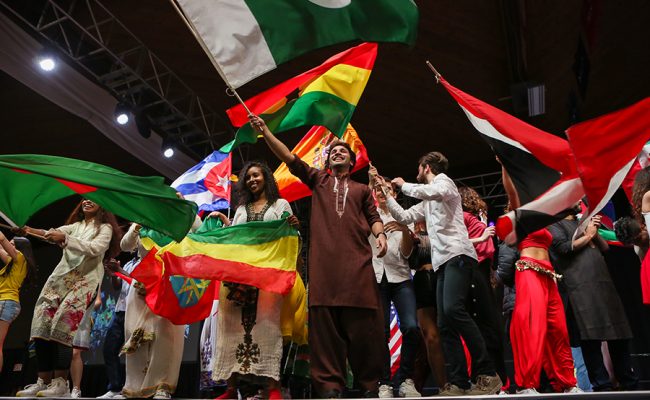 students holding up international flags