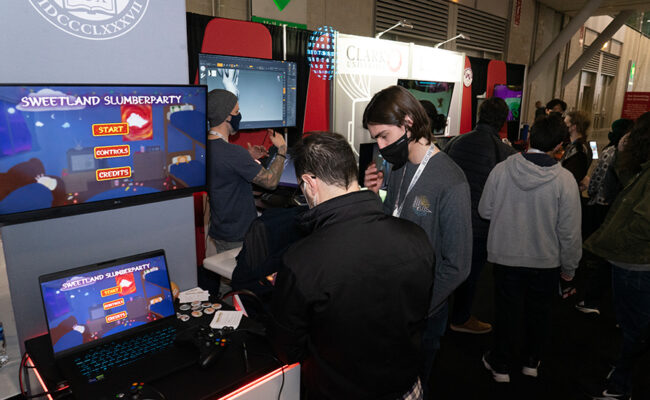 People trying games at BSDT booth