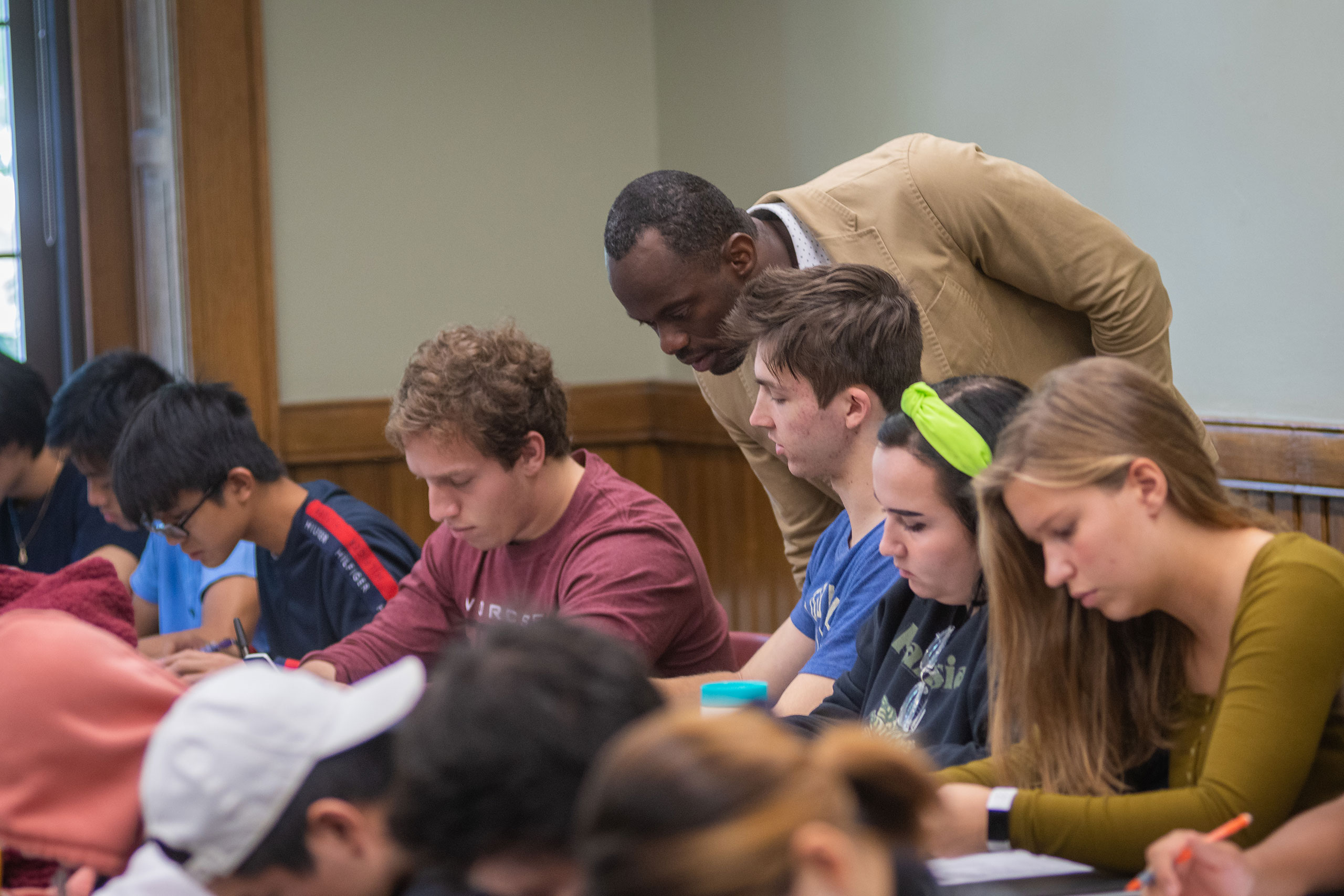 A professor checks a student's work in the Department of Economics, Clark University